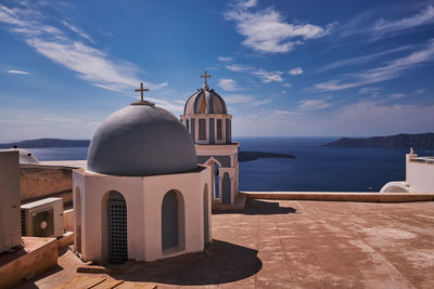  small church of st. mark the evangelist with its blue dome and colorful bell tower - santorini