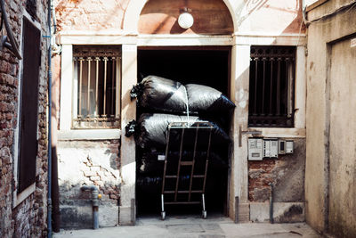 Garbage bags on cart in doorway of house