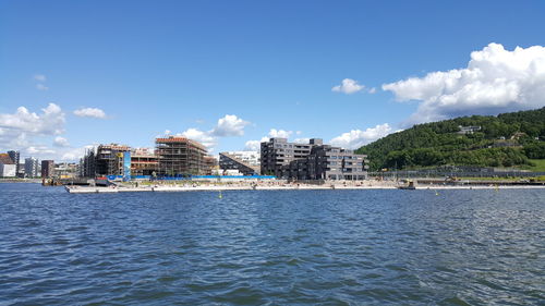 Calm sea with buildings in background