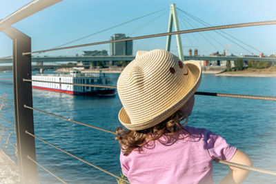 Rear view girl wearing hat at harbor