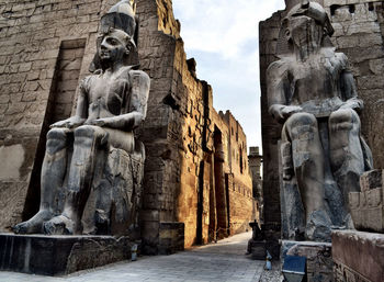 Low angle view of pharaoh statues at luxor temple