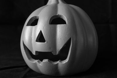 Close-up of pumpkin face against black background