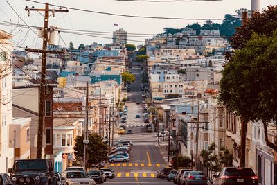 View of city street and buildings against sky