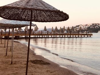 Gazebo on beach against sky