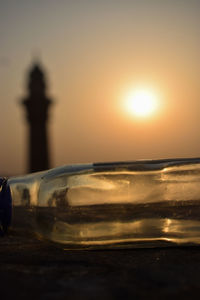 Close-up of sea against sky at sunset