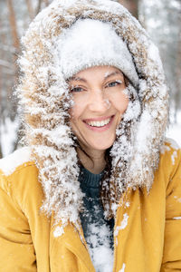 Portrait of a smiling woman in snow