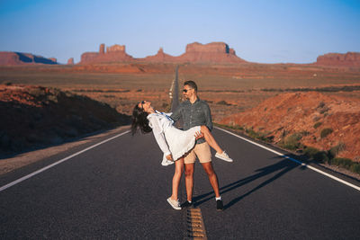 Full length of woman walking on road