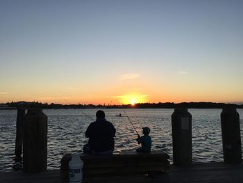 Pier on sea at sunset