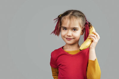 Portrait of smiling girl against white background