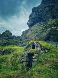 Scenic view of a turf house against sky in iceland 