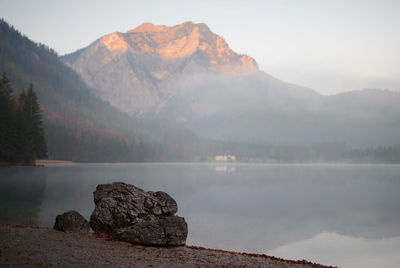 Scenic view of lake and mountains against sky