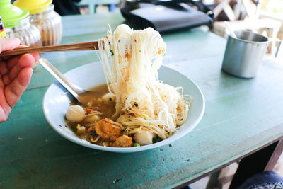 Close-up of man holding food on table