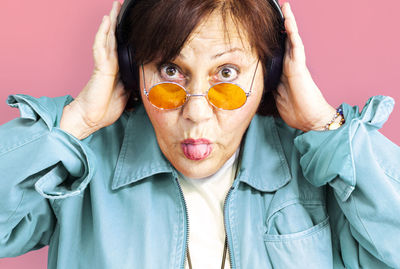 Close-up portrait of man wearing mask against gray background
