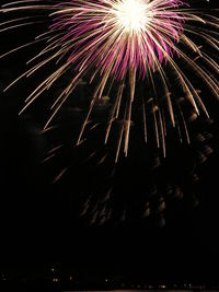 Low angle view of firework display at night