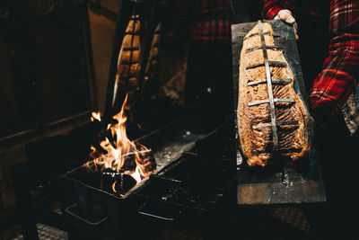 Midsection of person preparing salmon