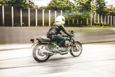 Blurred motion of man cycling on road