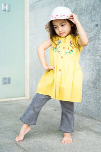 Little gorgeous toddler girl in summer clothes, fashion dress, and hat. happy asian child in outdoor