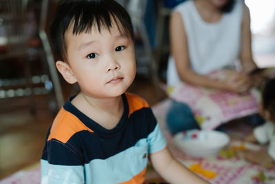 Close-up portrait of boy sitting at home