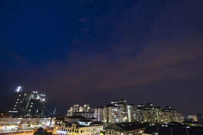 High angle view of illuminated buildings against sky at night