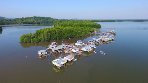 High angle view of trees by lake against sky