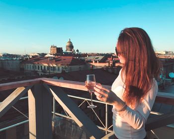 Woman having wine in city