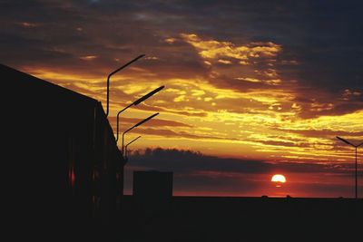 Silhouette of built structures at sunset