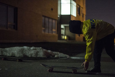 Rear view of man standing at night