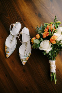 High angle view of white roses in vase on table