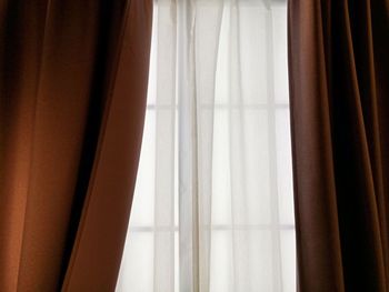 Close-up of curtain against window at home