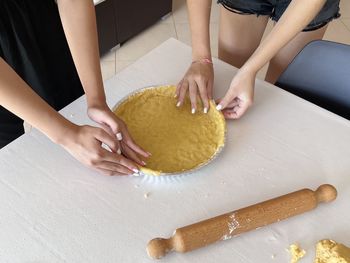 Girls cooking tart , young women making dessert 