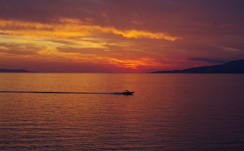 Scenic view of sea against orange sky