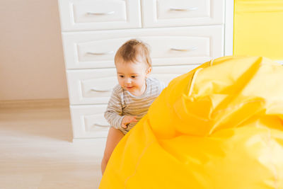 Cute boy looking at camera at home