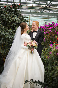 Bride and bridegroom holding bouquet