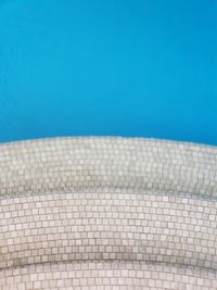 Low angle view of swimming pool against clear blue sky