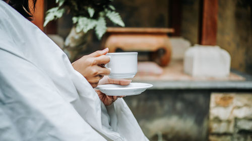 Woman holding coffee cup