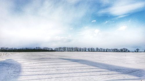 Scenic view of snow covered landscape against sky