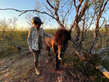 Full length of woman and horse