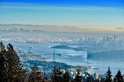 High angle view of buildings by sea against sky