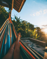 Low section of person relaxing on hammock