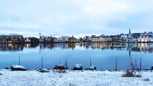 Panoramic view of boats moored at harbor against sky