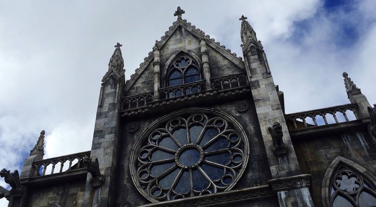 low angle view, architecture, sky, building exterior, travel destinations, built structure, no people, outdoors, city, religion, rose window, day, cloud - sky, place of worship, clock, time, clock tower, astronomical clock