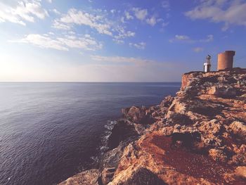 Scenic view of sea by buildings against sky