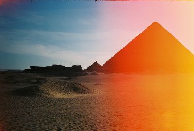 Scenic view of desert against sky during sunset