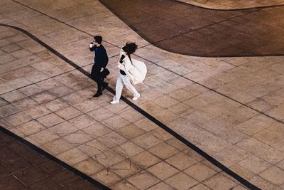 High angle view of couple walking on footpath