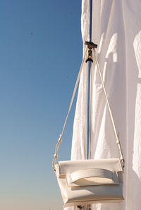 Low angle view of rope against clear blue sky