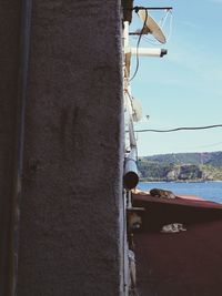 Close-up of sailboat moored on sea against sky