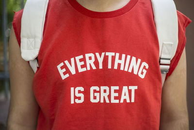 Rear view of man with text on red t-shirt