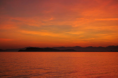 Scenic view of sea against orange sky