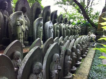 Male statues in a row at temple