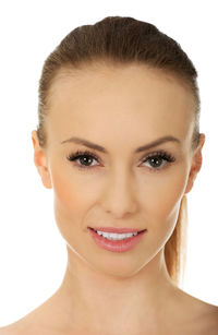 Close-up portrait of a smiling young woman over white background